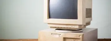 Old,And,Obsolete,Computer,On,Old,Wood,Table,With,Concrete