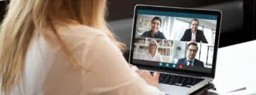 Back,View,Of,Businesswoman,Speak,Using,Webcam,Conference,On,Laptop