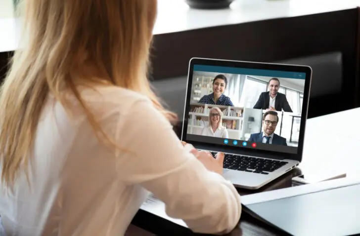 Back,View,Of,Businesswoman,Speak,Using,Webcam,Conference,On,Laptop