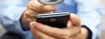 Businessman,Using,Mobile,Smart,Phone,With,Magnifying,Glass,.,Phone