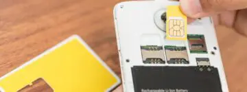 Hand,Insert,New,Sim,Card,With,Smart,Phone.